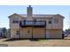 Rear view of home features a large deck for outdoor entertainment and relaxation at 195 Brighton Dr, Covington, GA 30016