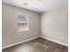 Bedroom featuring hardwood floors, neutral walls, and a window at 195 Brighton Dr, Covington, GA 30016