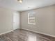 Bedroom with a window, wood-look flooring, and door at 195 Brighton Dr, Covington, GA 30016