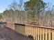 View of the wooden deck with railing overlooking a grassy yard and trees at 195 Brighton Dr, Covington, GA 30016