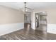 Bright dining room featuring hardwood floors and modern light fixture that connects to the kitchen at 195 Brighton Dr, Covington, GA 30016