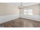 Dining room with modern chandelier, neutral walls and hardwood floors, creating a cozy ambiance at 195 Brighton Dr, Covington, GA 30016