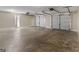 Large three car garage with three white garage doors and concrete flooring at 195 Brighton Dr, Covington, GA 30016