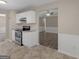 Bright kitchen featuring stainless steel oven and white cabinetry at 195 Brighton Dr, Covington, GA 30016