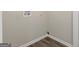 Laundry room featuring neutral walls and hardwood floors at 195 Brighton Dr, Covington, GA 30016