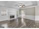 Living room with bright walls, wood flooring, a ceiling fan, and a marble fireplace at 195 Brighton Dr, Covington, GA 30016