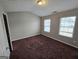 Spacious bedroom with two windows and neutral-toned walls and carpeting at 6206 Flat Trace, South Fulton, GA 30291