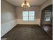 Light-filled dining area with a classic chandelier and a view to the main entry at 6206 Flat Trace, South Fulton, GA 30291