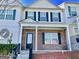 Charming townhouse featuring a brick facade, black shutters and inviting covered entrance at 6206 Flat Trace, South Fulton, GA 30291