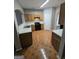 Well-lit kitchen with tile floor, wood cabinets, and black appliances at 6206 Flat Trace, South Fulton, GA 30291