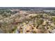 Aerial view of a neighborhood showcasing well-maintained homes, mature trees, and a tranquil, winding street at 10175 Point View Dr, Jonesboro, GA 30238