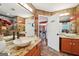 Nicely tiled bathroom featuring double vanities and an open doorway to another bedroom at 10175 Point View Dr, Jonesboro, GA 30238