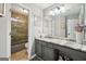 Well-lit bathroom featuring a neutral palette with granite countertops and a glass-enclosed shower at 10175 Point View Dr, Jonesboro, GA 30238