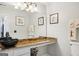 Stylish bathroom with a black vessel sink atop a gold and brown granite countertop and decorative art at 10175 Point View Dr, Jonesboro, GA 30238