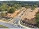 Stone pillars and lush landscaping highlight the entrance to a new private community at 4510 Natchez, Cumming, GA 30040