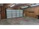 Unfinished garage featuring an open garage door, offering ample space and potential for various uses at 97 Arnold Rd, Hampton, GA 30228