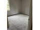 Cozy bedroom with neutral walls, plush carpet, and ample natural light from a large window at 1700 Mccollum Rd, Sw, Conyers, GA 30094