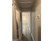 Hallway featuring modern flooring and neutral paint, leading to a room with a chandelier at 1700 Mccollum Rd, Sw, Conyers, GA 30094