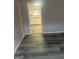 View of the kitchen from the living room, showing open concept and modern flooring at 1700 Mccollum Rd, Sw, Conyers, GA 30094