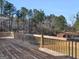 Spacious back deck overlooks expansive yard with privacy fence and wooded backdrop at 231 Ashley Trace Dr, Locust Grove, GA 30248