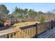 View of a spacious back deck with wooden rails overlooking the backyard and shed at 231 Ashley Trace Dr, Locust Grove, GA 30248