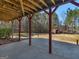 Under deck patio featuring concrete flooring, wooden supports, and spacious yard area at 231 Ashley Trace Dr, Locust Grove, GA 30248