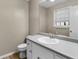Bathroom featuring white cabinets, gray countertops, sink, and toilet at 231 Ashley Trace Dr, Locust Grove, GA 30248