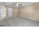 Bedroom features neutral walls, plush carpet, ceiling fan, and doorway at 231 Ashley Trace Dr, Locust Grove, GA 30248