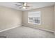 Cozy bedroom with neutral carpet and a window offering natural light at 231 Ashley Trace Dr, Locust Grove, GA 30248