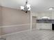 Dining area with tile floors, white cabinetry, and modern light fixture at 231 Ashley Trace Dr, Locust Grove, GA 30248