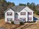 Two story home featuring classic white siding and red shutters with a lawn and mature trees at 231 Ashley Trace Dr, Locust Grove, GA 30248