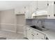 Kitchen featuring white cabinets, stainless steel sink and faucet at 231 Ashley Trace Dr, Locust Grove, GA 30248