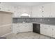 Kitchen with white cabinets, stainless steel sink, and black dishwasher at 231 Ashley Trace Dr, Locust Grove, GA 30248