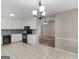 Bright kitchen featuring tile flooring, white cabinets, and black appliances at 231 Ashley Trace Dr, Locust Grove, GA 30248