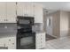 Kitchen with black microwave and oven range, and white cabinets at 231 Ashley Trace Dr, Locust Grove, GA 30248