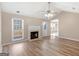Sunlit living room with vinyl floors, fireplace, and vaulted ceilings at 231 Ashley Trace Dr, Locust Grove, GA 30248