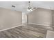 Spacious living room with vaulted ceilings, neutral walls, and vinyl flooring at 231 Ashley Trace Dr, Locust Grove, GA 30248