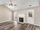 Bright living room with vinyl floors, fireplace, door to exterior, and vaulted ceilings at 231 Ashley Trace Dr, Locust Grove, GA 30248
