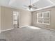 Spacious primary bedroom with trey ceilings, carpet flooring, and ensuite bathroom at 231 Ashley Trace Dr, Locust Grove, GA 30248