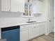 Bright kitchen featuring white cabinets, quartz countertops, stainless steel sink, and modern appliances at 20 Eastwood Ter, Covington, GA 30014