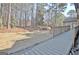 A backyard featuring a wooden deck, natural landscaping, and a serene view of the surrounding greenery at 245 Highview Trce, Fayetteville, GA 30215