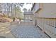 A peaceful backyard offering a spacious wooden deck, a stone wall, and serene natural landscaping at 245 Highview Trce, Fayetteville, GA 30215