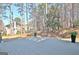 A spacious backyard featuring a wooden deck, mature trees, and peaceful surroundings at 245 Highview Trce, Fayetteville, GA 30215