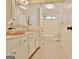 Bathroom featuring a dual sink vanity, decorative mirrors, and a shower/tub combo at 245 Highview Trce, Fayetteville, GA 30215
