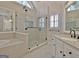 Bright bathroom featuring a glass shower, soaking tub, and a window providing natural light at 245 Highview Trce, Fayetteville, GA 30215