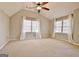 Bedroom with neutral walls and carpet, two windows with curtains, and a ceiling fan at 245 Highview Trce, Fayetteville, GA 30215
