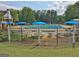Inviting community pool area with umbrellas and lounge chairs, perfect for relaxation and recreation at 245 Highview Trce, Fayetteville, GA 30215