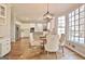 Bright dining area with modern chandelier, hardwood floors, and views of the updated kitchen at 245 Highview Trce, Fayetteville, GA 30215