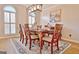 Dining room featuring a wooden table, chairs, a stylish light fixture and an arched window at 245 Highview Trce, Fayetteville, GA 30215