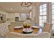 Close-up of dining table, showing seating and view into the modern, renovated kitchen at 245 Highview Trce, Fayetteville, GA 30215